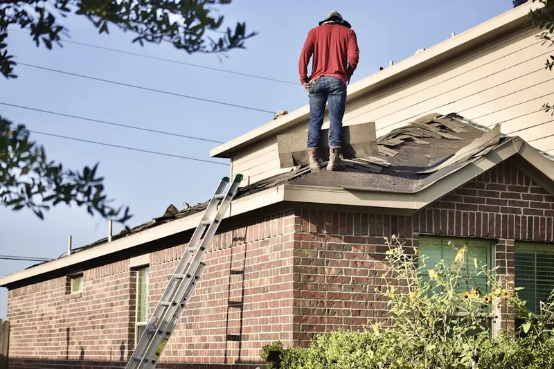 Professional roofer working on a residential roof in Tamarisk Country Club